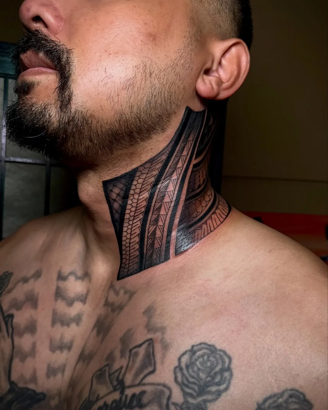 Neck and chest tribal tattoo by Don Xavier