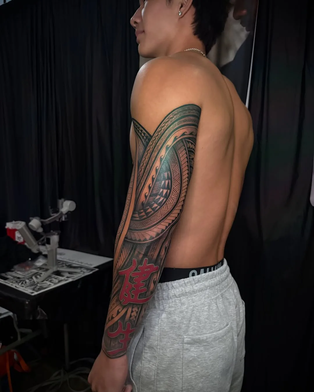 Back and sleeve tribal tattoo by Don Xavier