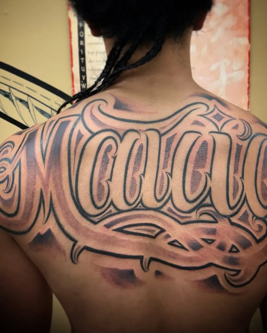 Script back piece tattoo by To'a