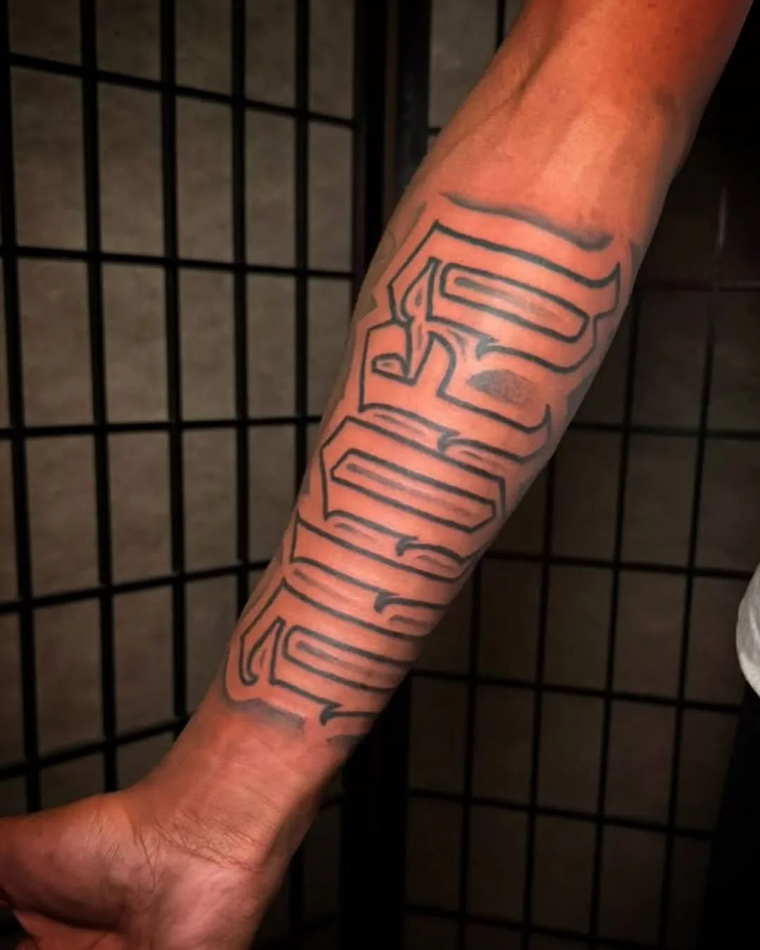 Forearm lettering tattoo by To'a